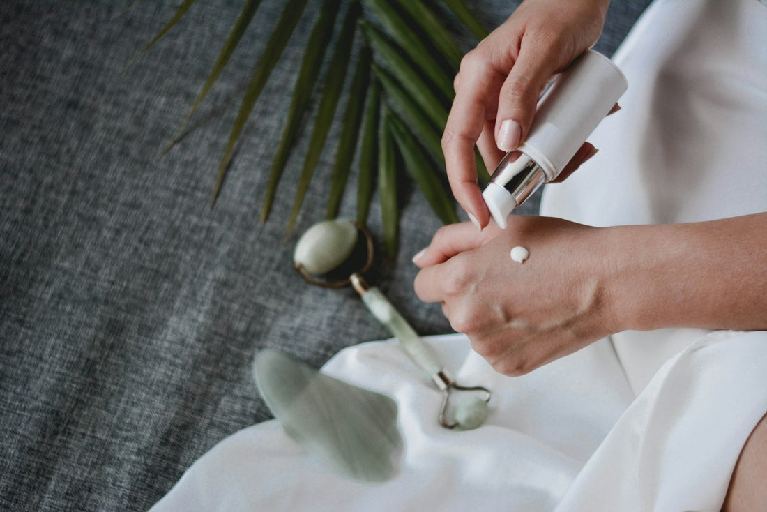 Woman practicing an at-home skincare routine with a facial massage tool
